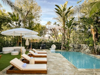 Daytime poolside lounge with white umbrella